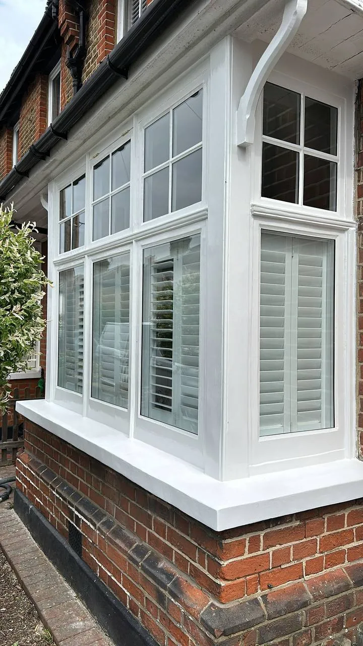 Restored white timber bay window with glossy paintwork