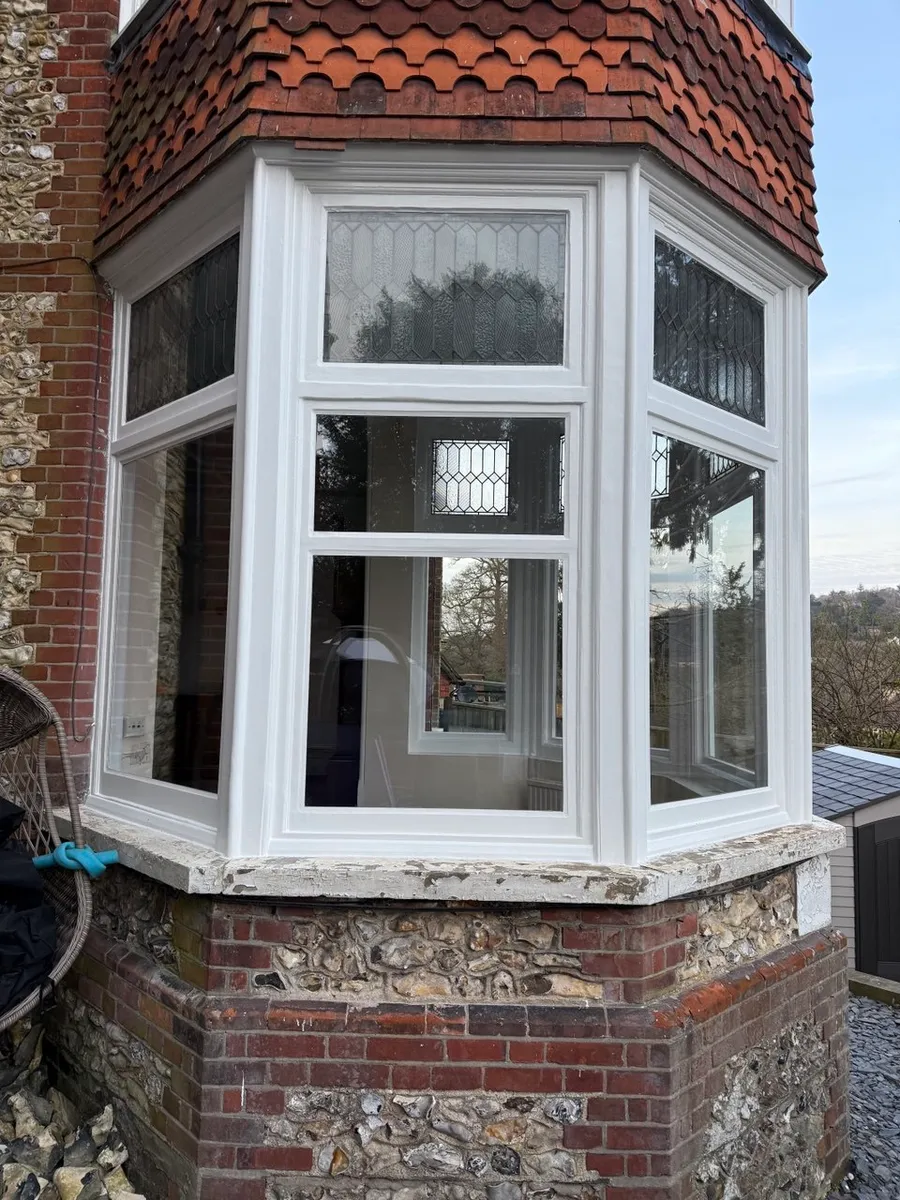 Restored timber sash window on a period brick house
