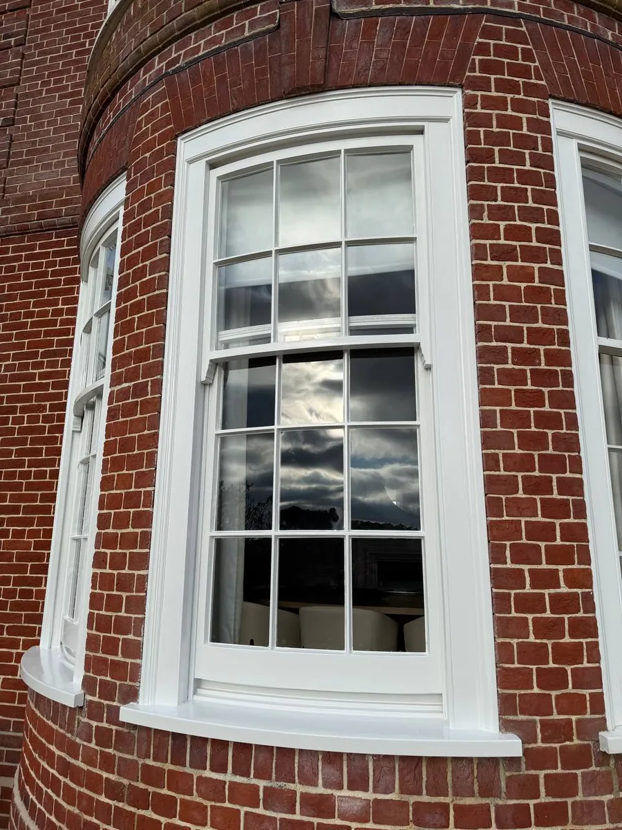 Restored timber sash window on a period brick house