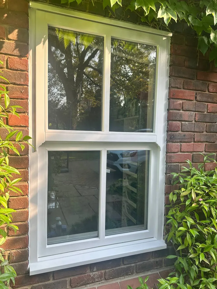Restored timber sash window on a period brick house